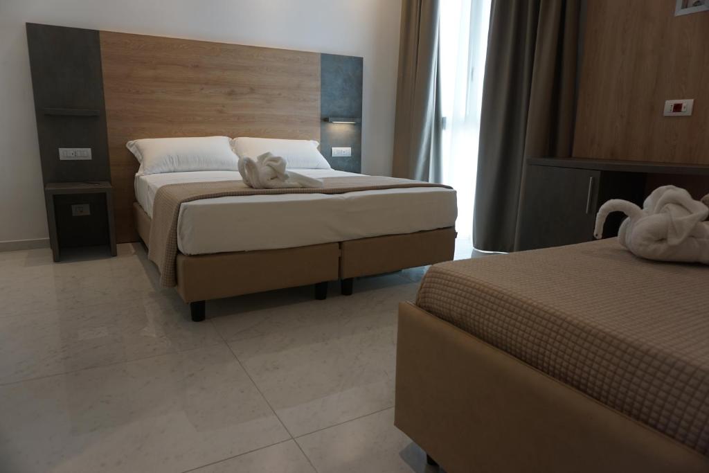 Postel nebo postele na pokoji v ubytování Hotel Ducale