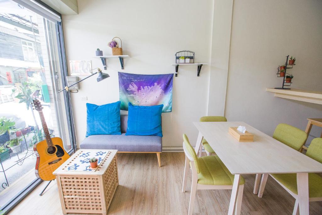 a living room with a couch and a table at KM Hostel in Chiayi City