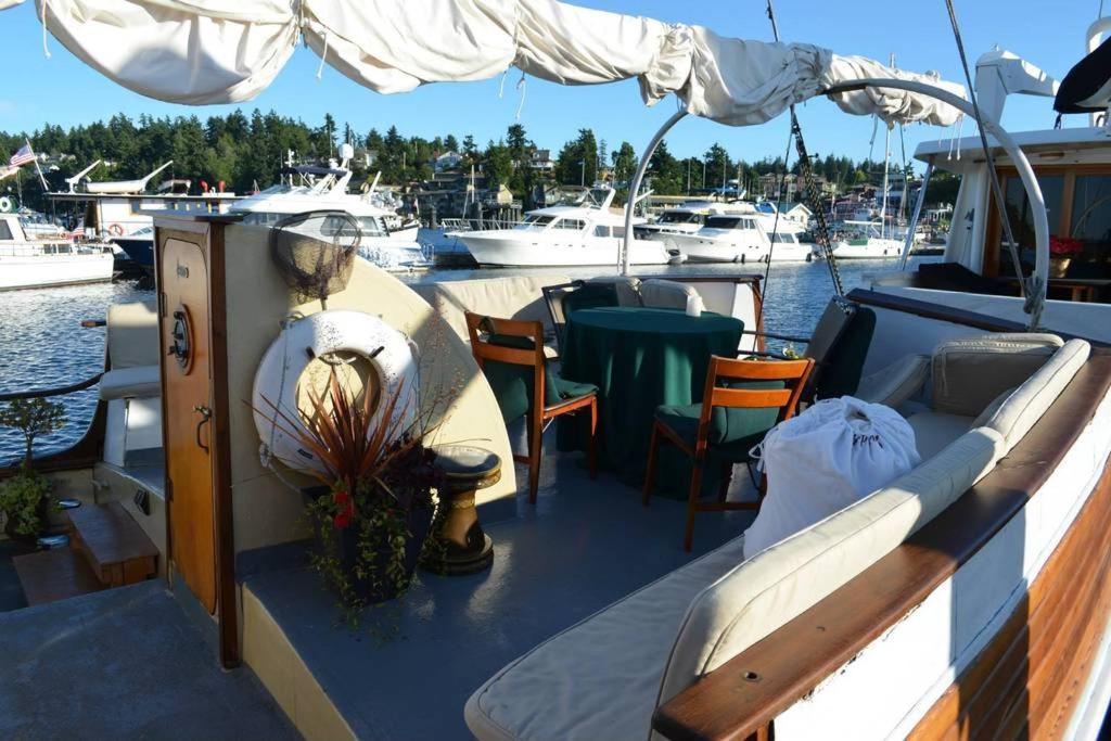 a boat with a table and chairs on the deck at Wharfside Bed & Breakfast in Friday Harbor