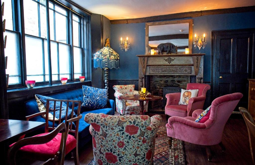 a living room with chairs and a table and a fireplace at The Old Vicarage Hotel & Restaurant in Bridgwater