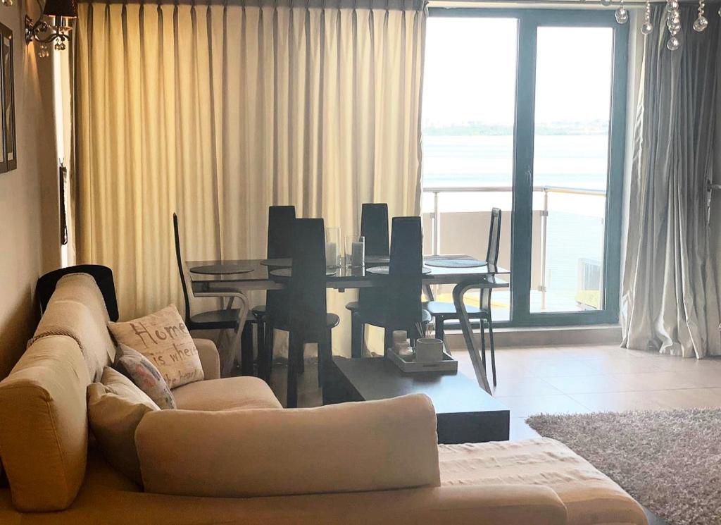 a living room with a couch and a dining table at Apartament Vila Maria in Mamaia