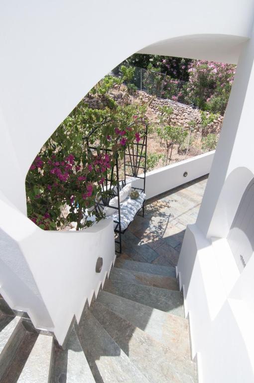 a view from the stairs of a house with flowers at Nautilus Nontas Hotel in Megalochori