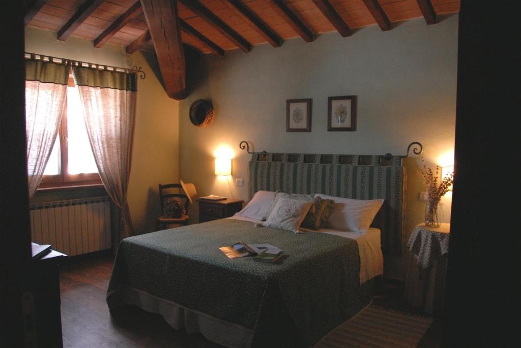 a bedroom with a bed in a room with two windows at La Pintura in Trevi