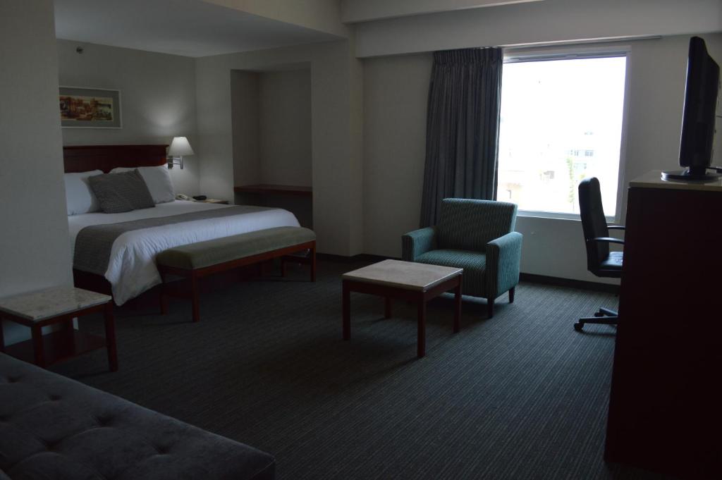Postel nebo postele na pokoji v ubytování Casa Inn Business Hotel Celaya