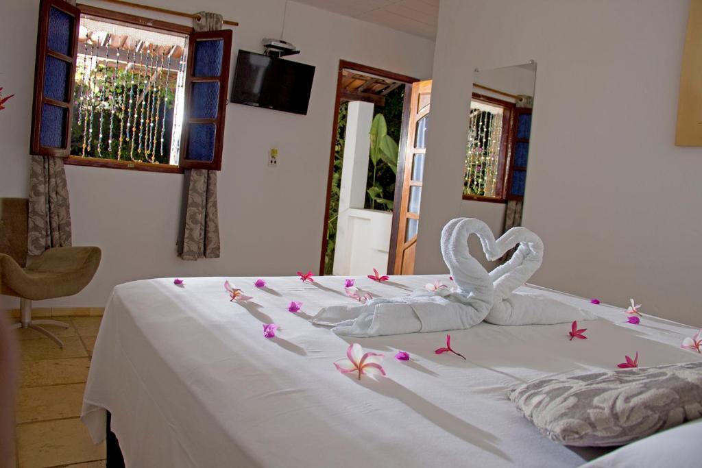 Cama ou camas em um quarto em Pousada Villa Caju