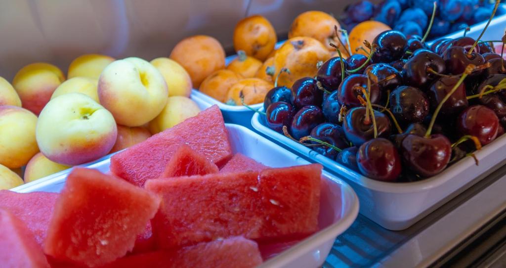 a display of fruit in trays on a table at Hostal Casa Mercedes in Nerja