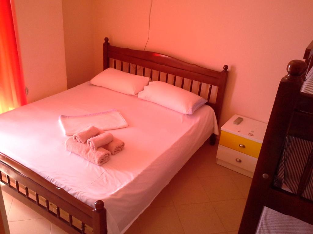 a bedroom with a bed with a stuffed animal on it at Nada SeaView Apartment in Shëngjin