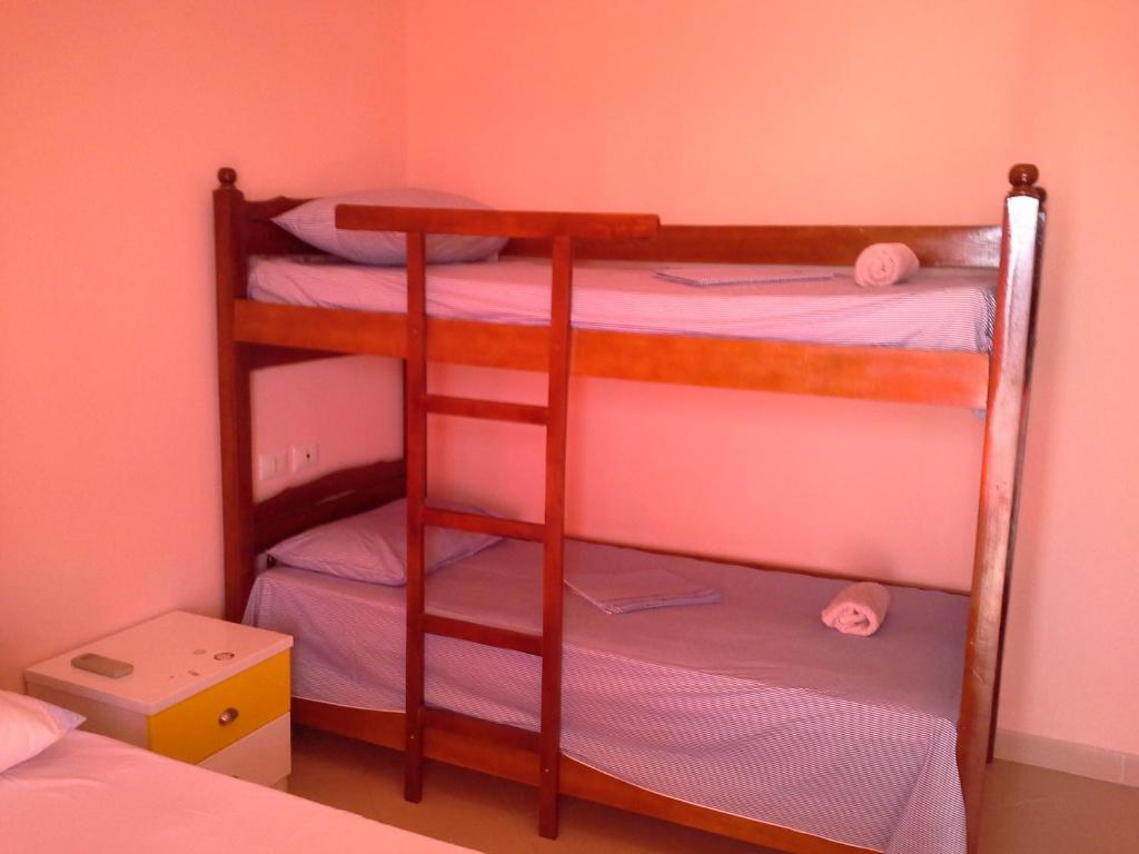 two bunk beds in a room with pink walls at Nada SeaView Apartment in Shëngjin