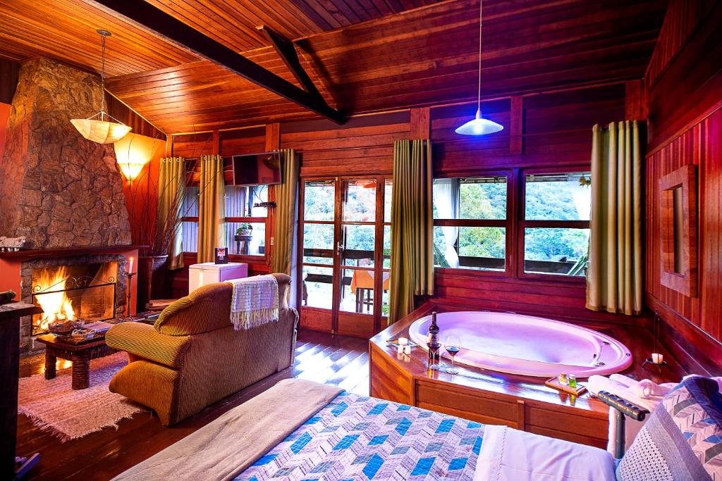 a living room with a tub in a room at Pousada Verde Água Visconde de Mauá in Visconde De Maua