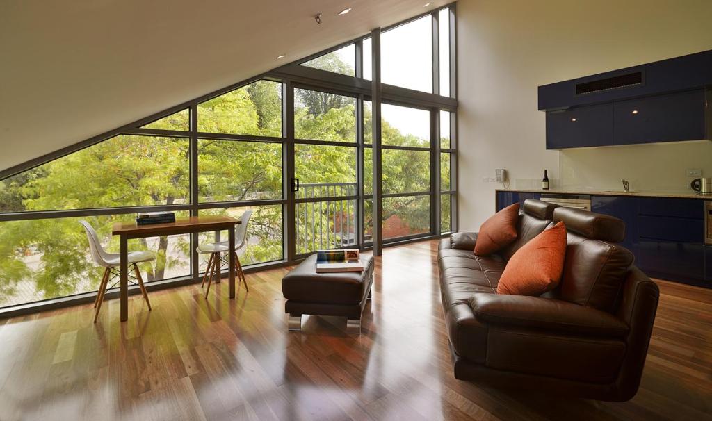 a living room with a couch and a table at Salamanca Wharf Hotel in Hobart