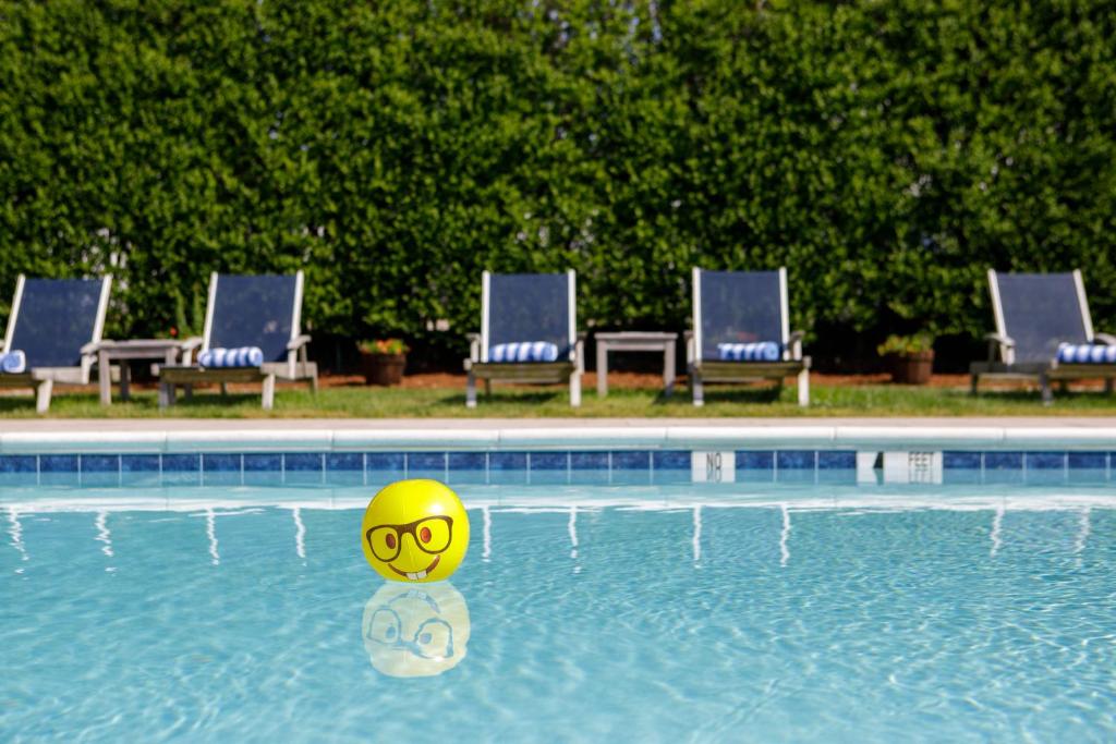 a yellow ball in the water in a swimming pool at The Ocean Resort Inn in Montauk