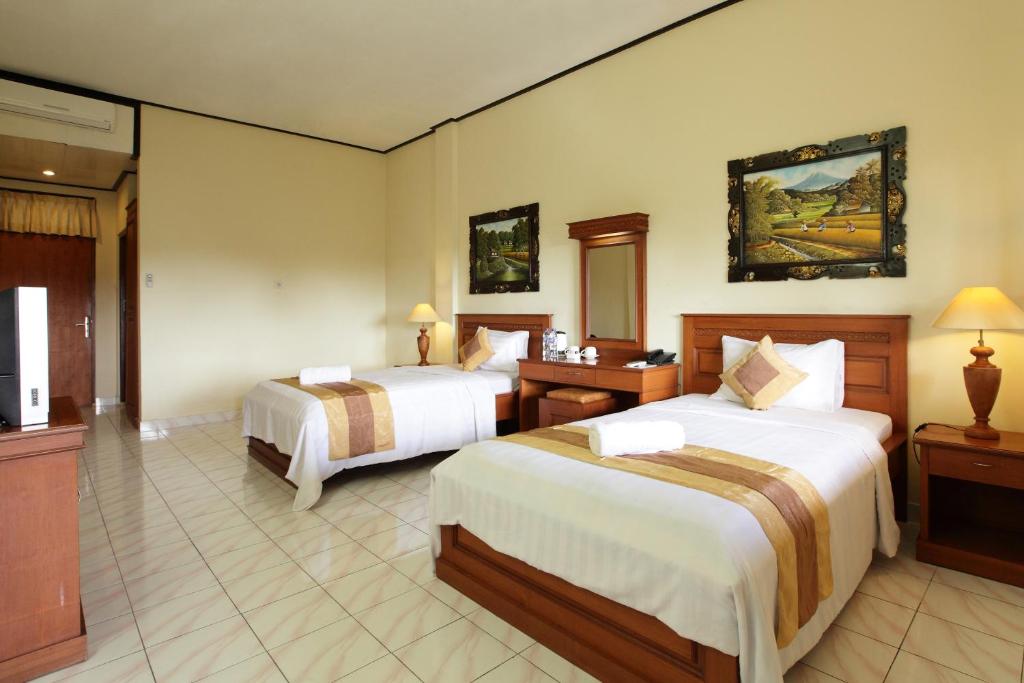 Postel nebo postele na pokoji v ubytování Bali Sandy Resort