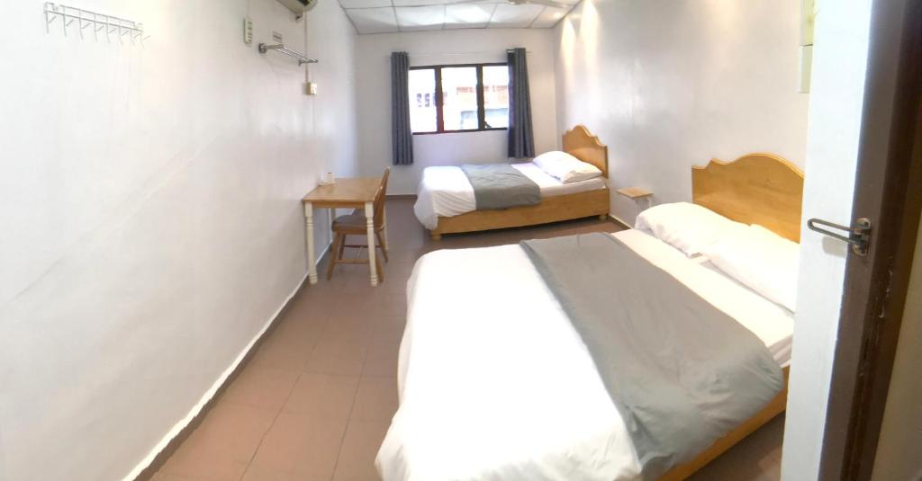 Postel nebo postele na pokoji v ubytování Grand Star Hotel