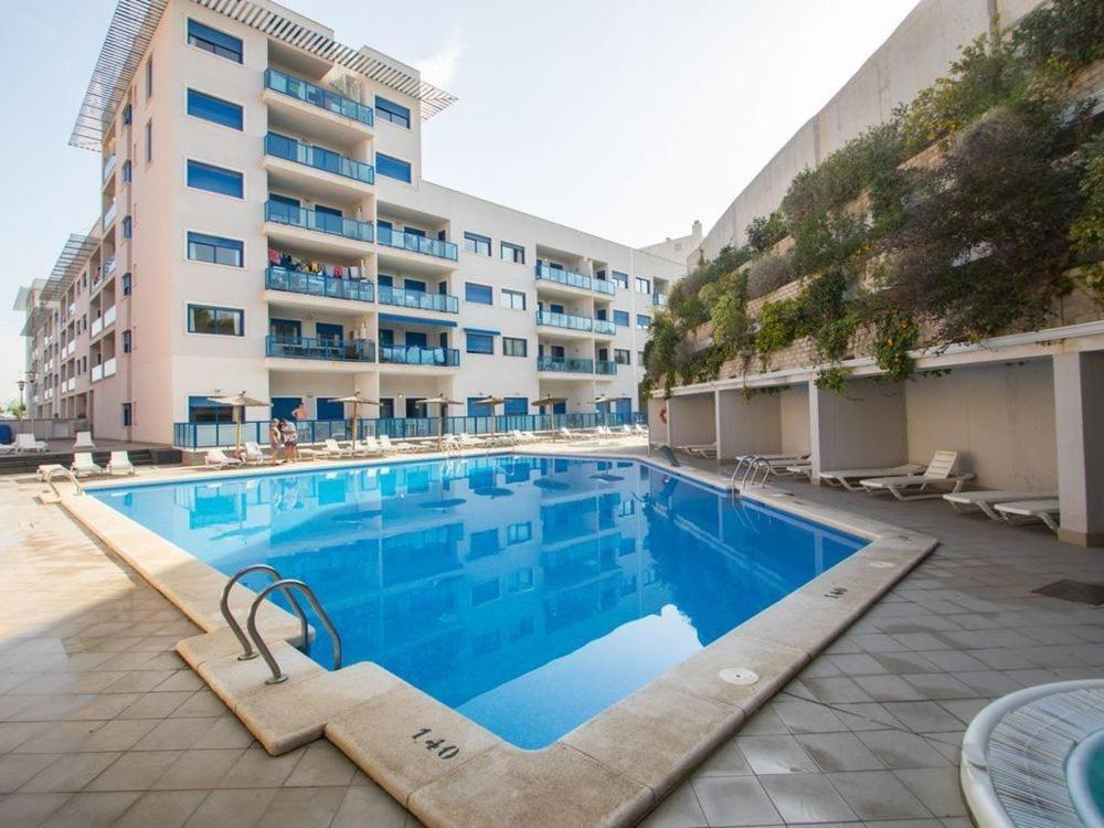 une grande piscine en face d'un bâtiment dans l'établissement Alicante Hills Beach & Golf, à Alicante