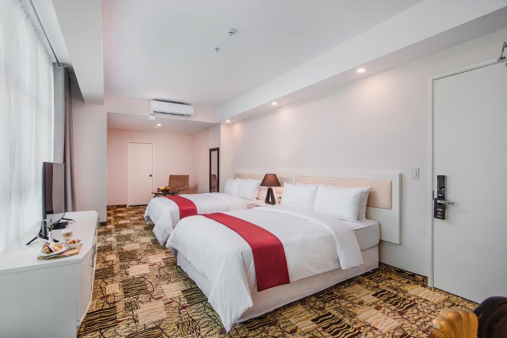Postel nebo postele na pokoji v ubytování Nobility Grand Hotel