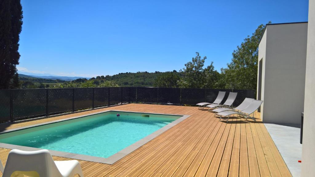 a swimming pool on the deck of a house at Villa piscine Sud France in Verzeille