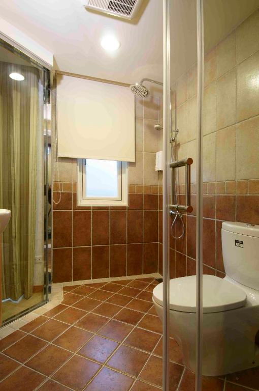 a bathroom with a toilet and a shower at Hotel Color in Taipei