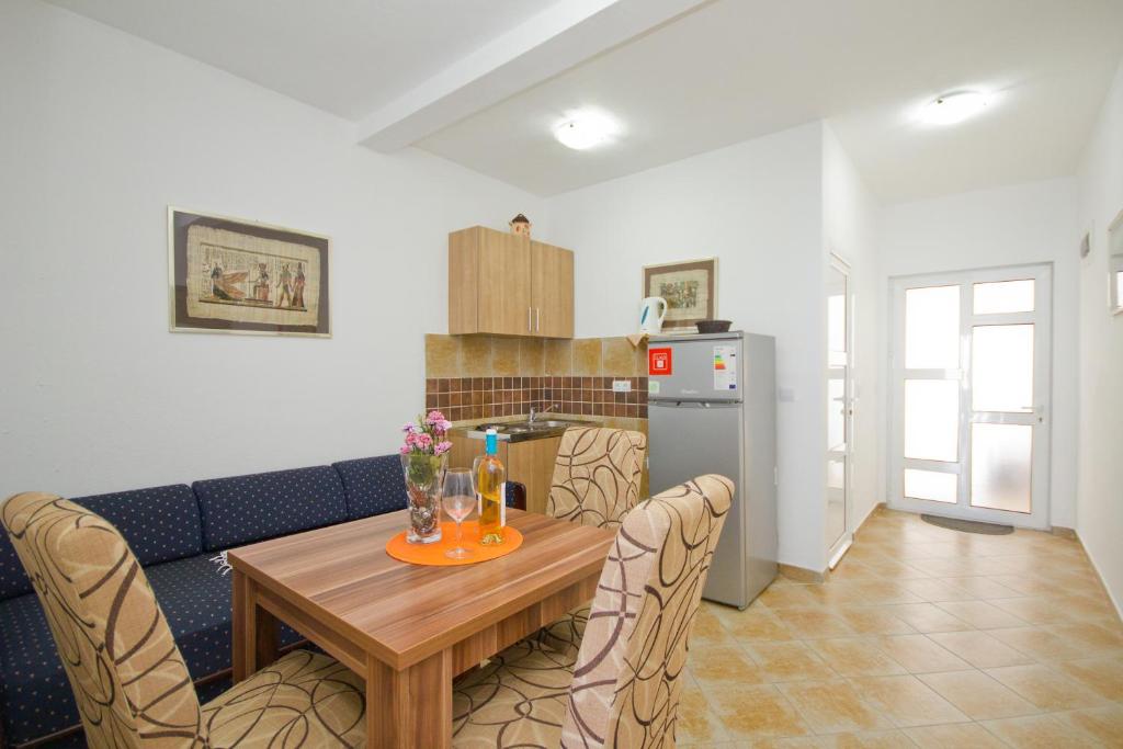 a kitchen and dining room with a table and chairs at Apartments Dora in Dobra Voda