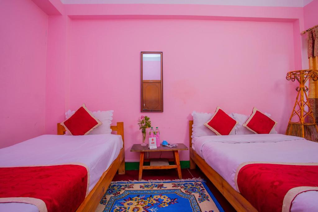 Postel nebo postele na pokoji v ubytování Sunrise Moon Beam Hotel