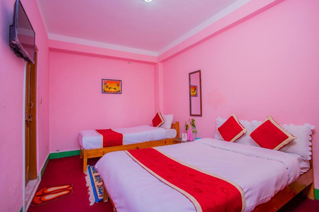Postel nebo postele na pokoji v ubytování Sunrise Moon Beam Hotel