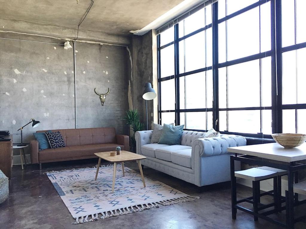 a living room with a couch and a table at City Loft w/ View of Gay St in Knoxville