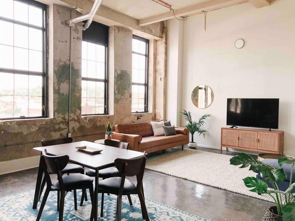 a living room with a table and a couch at Historic Sterchi Loft on Gay St in Knoxville