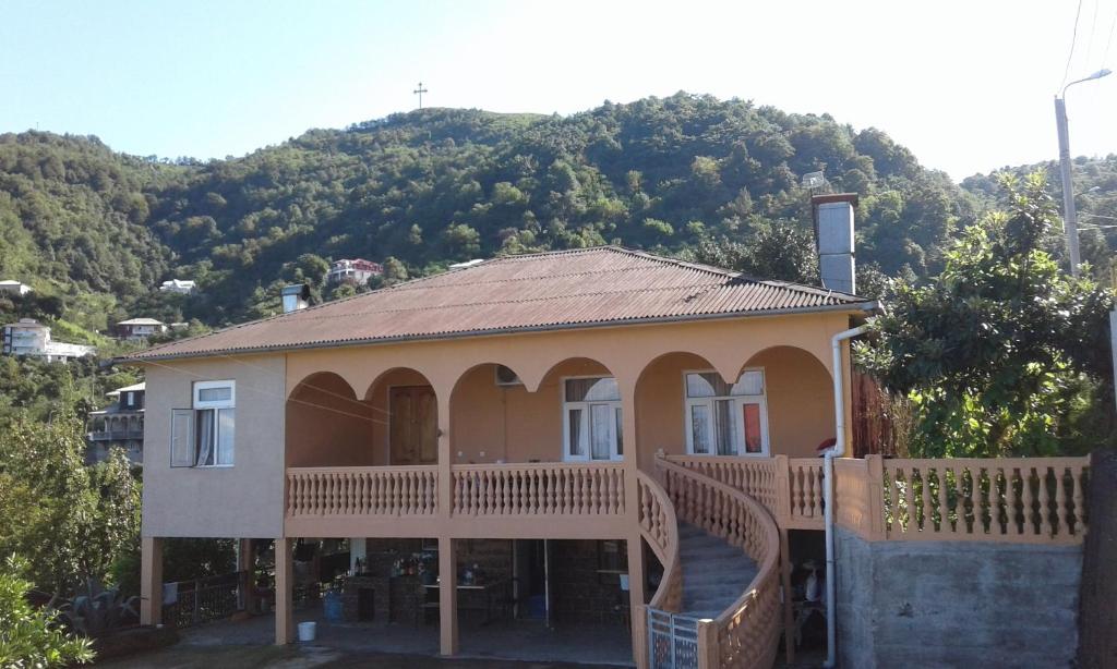 a house with a large deck with a mountain in the background at House Anna in Gonio