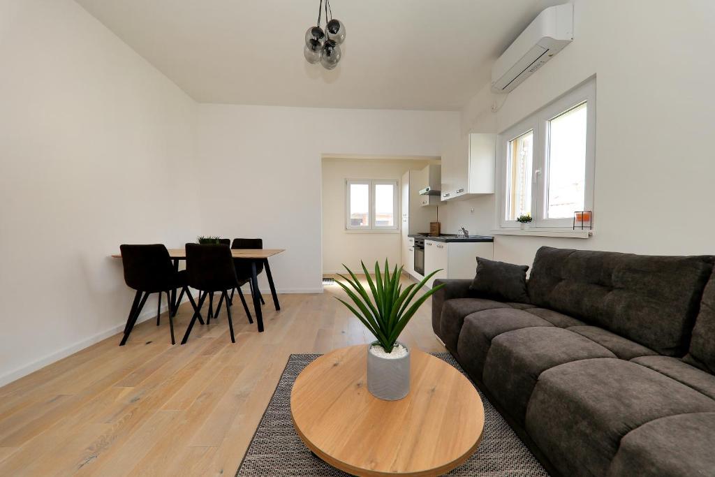 a living room with a couch and a table at Apartment Tia in Zadar