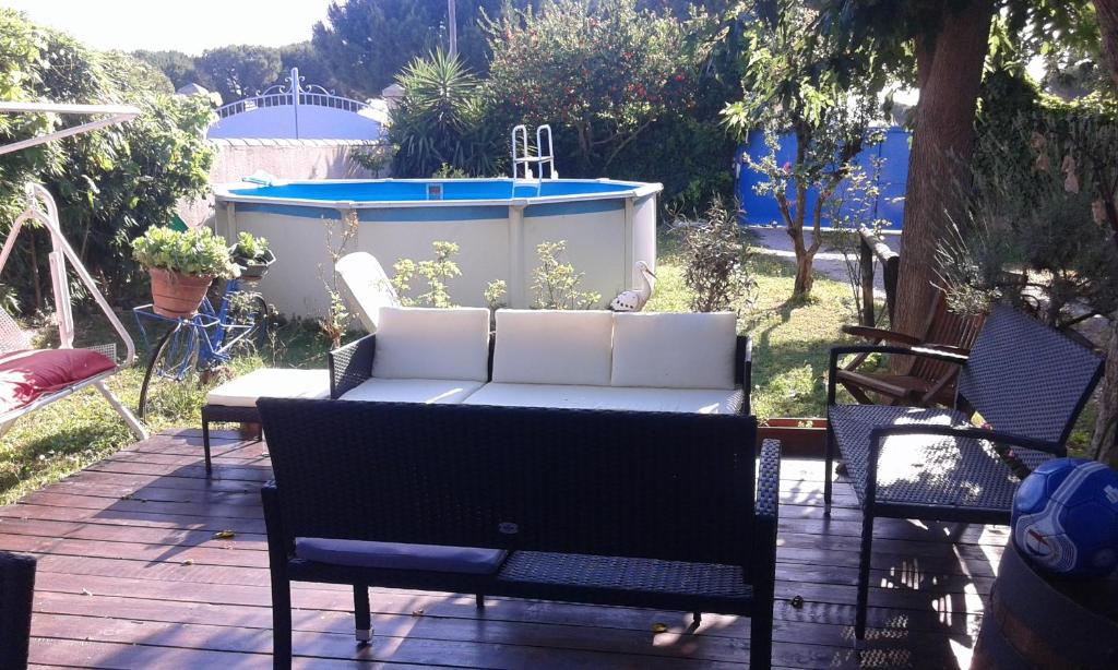 un patio avec un canapé blanc et une baignoire dans l'établissement Abrivado Aimargues en petite camargue, à Aimargues