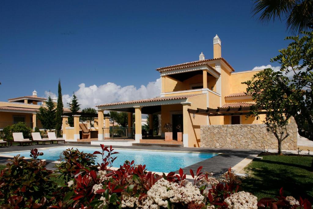 a large house with a swimming pool in front of it at Cascade Wellness Resort in Lagos