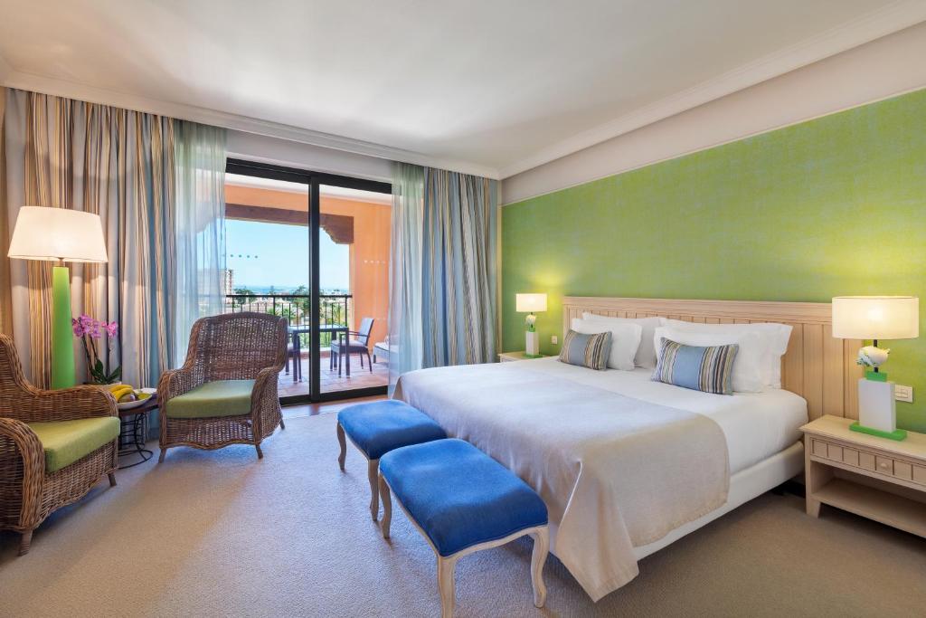 a hotel room with a large bed and a balcony at Cascade Wellness Resort in Lagos