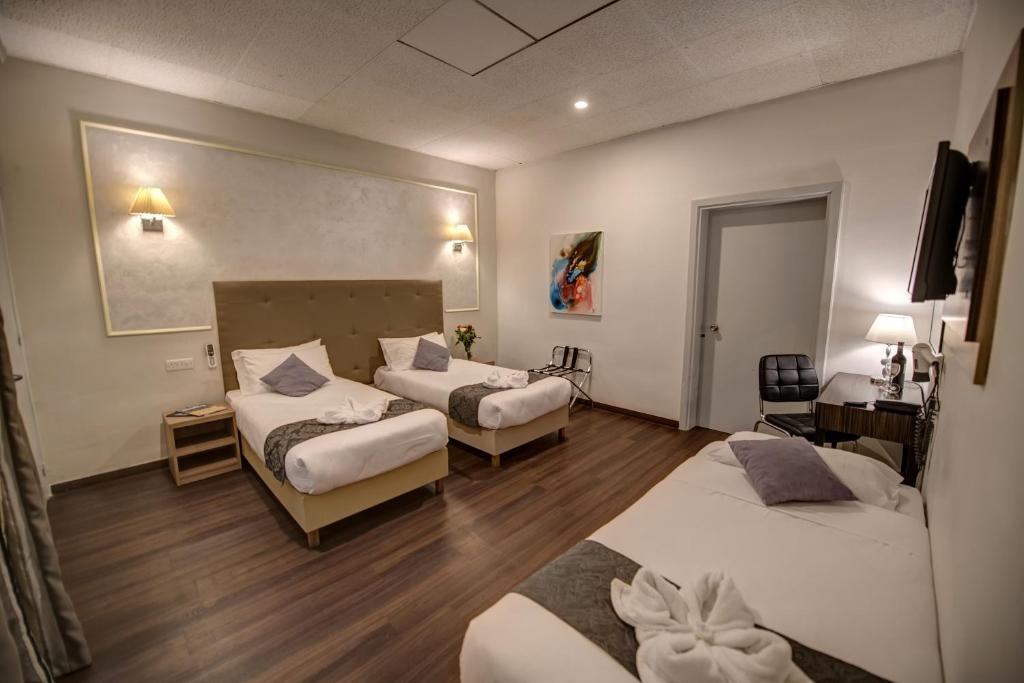 Postel nebo postele na pokoji v ubytování Europa Hotel
