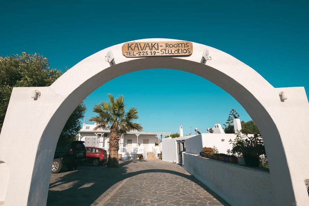 an archway over a driveway with a palm tree at Kavaki Studios in Mýkonos City