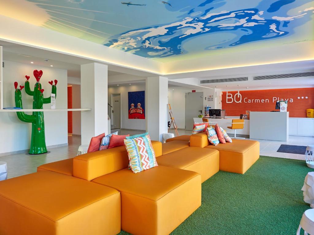 a lobby with orange couches in a store at BQ Carmen Playa- Adults Only in Playa de Palma