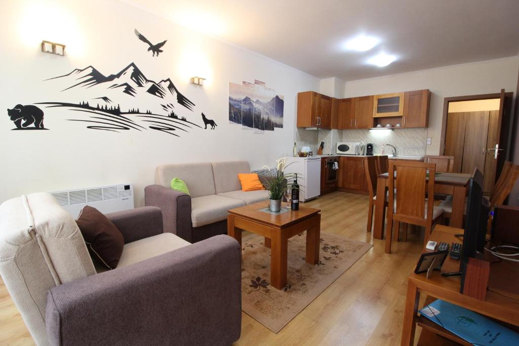 a living room with a couch and a kitchen at Pine Tree Apartment 2 - B7 in Bansko