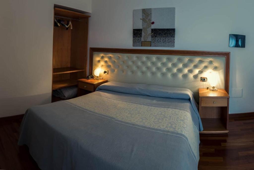 Postel nebo postele na pokoji v ubytování Hotel Del Corso