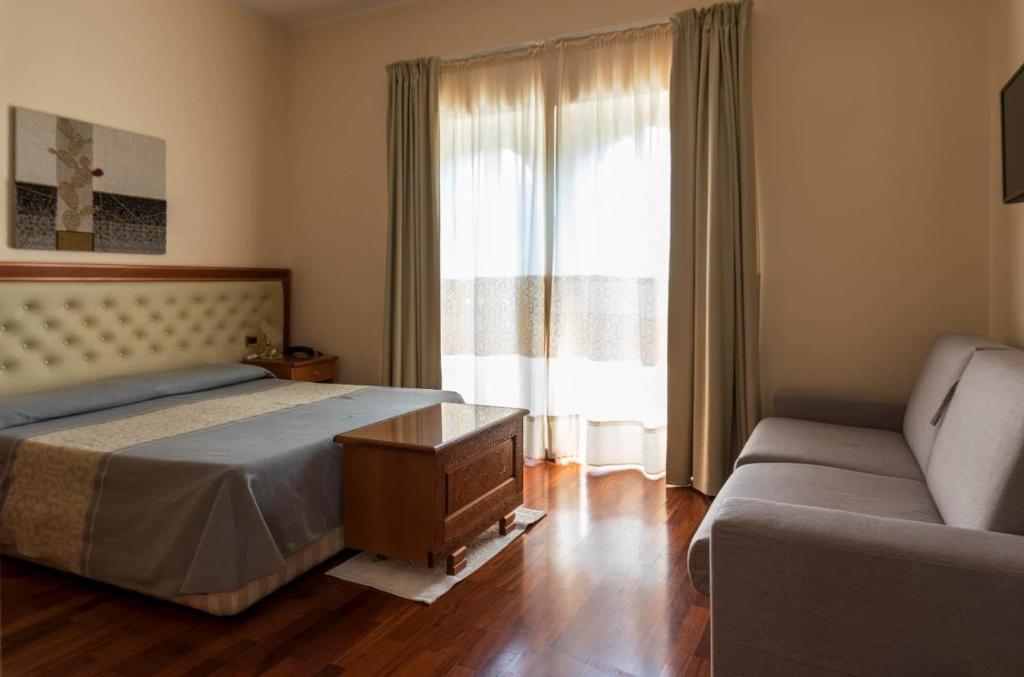 Postel nebo postele na pokoji v ubytování Hotel Del Corso