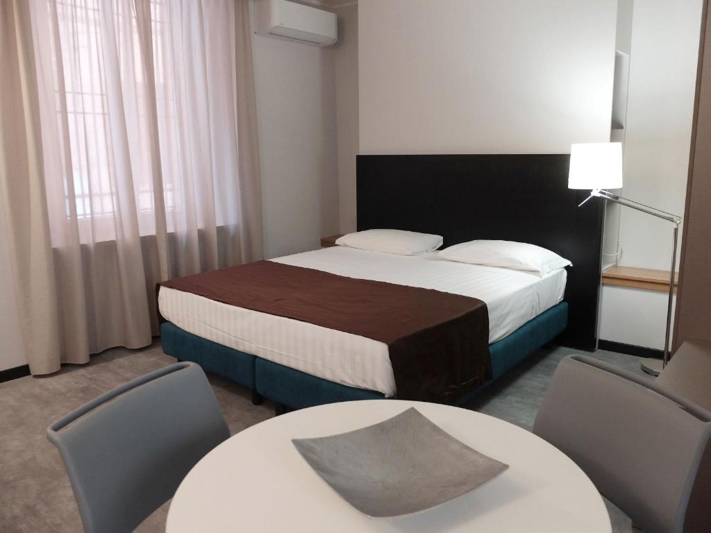 Postel nebo postele na pokoji v ubytování Hotel Carlton