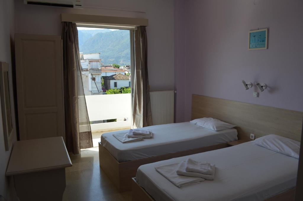 Postel nebo postele na pokoji v ubytování Dimitropoulos Apartments