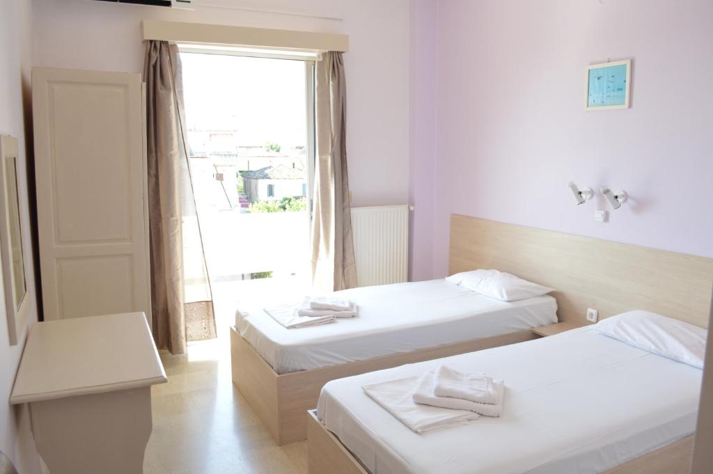 Postel nebo postele na pokoji v ubytování Dimitropoulos Apartments