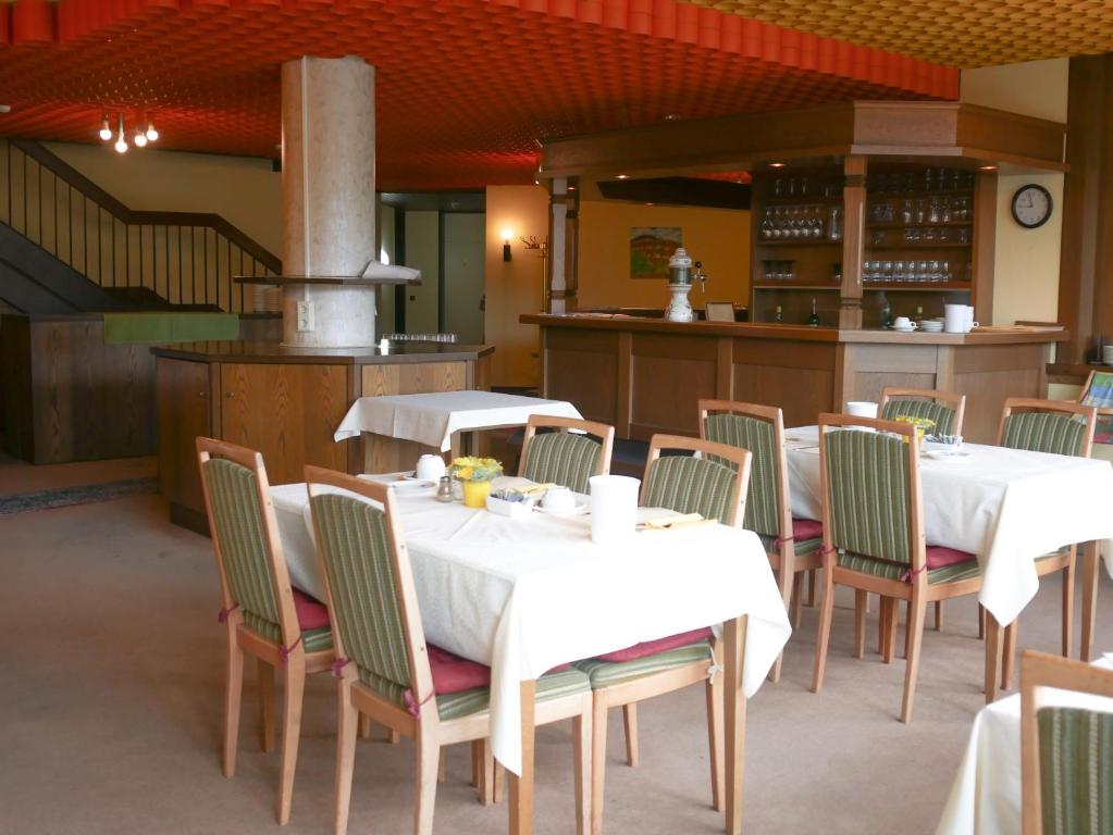a restaurant with two tables and chairs and a stove at Hotel Oronto in Koblenz