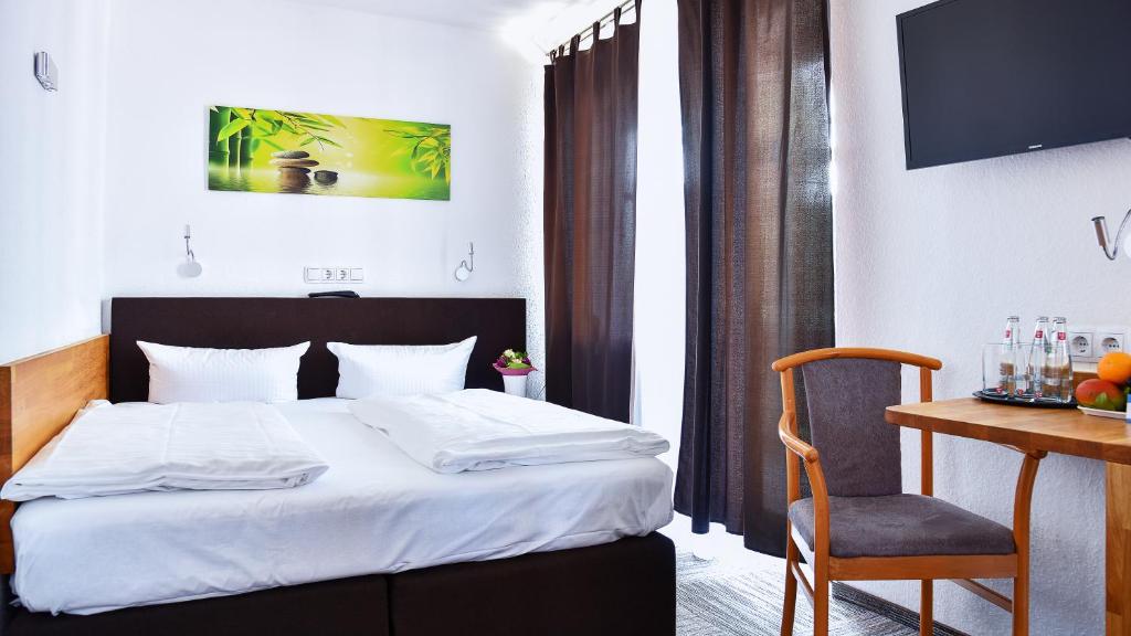 Cama o camas de una habitación en Hotel Mainbogen
