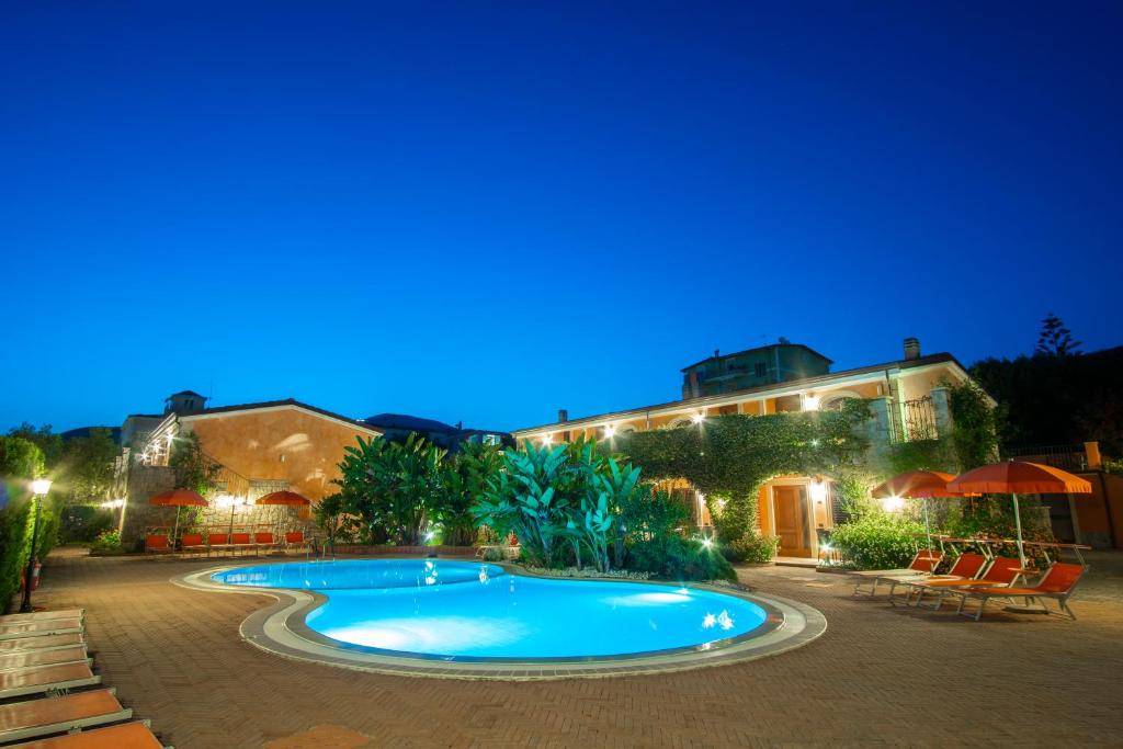 a swimming pool in front of a building at night at Residence Baia Infreschi in Marina di Camerota