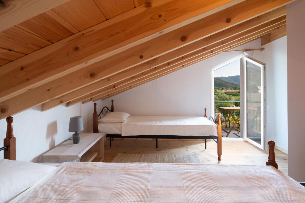 Postel nebo postele na pokoji v ubytování Pratsas House