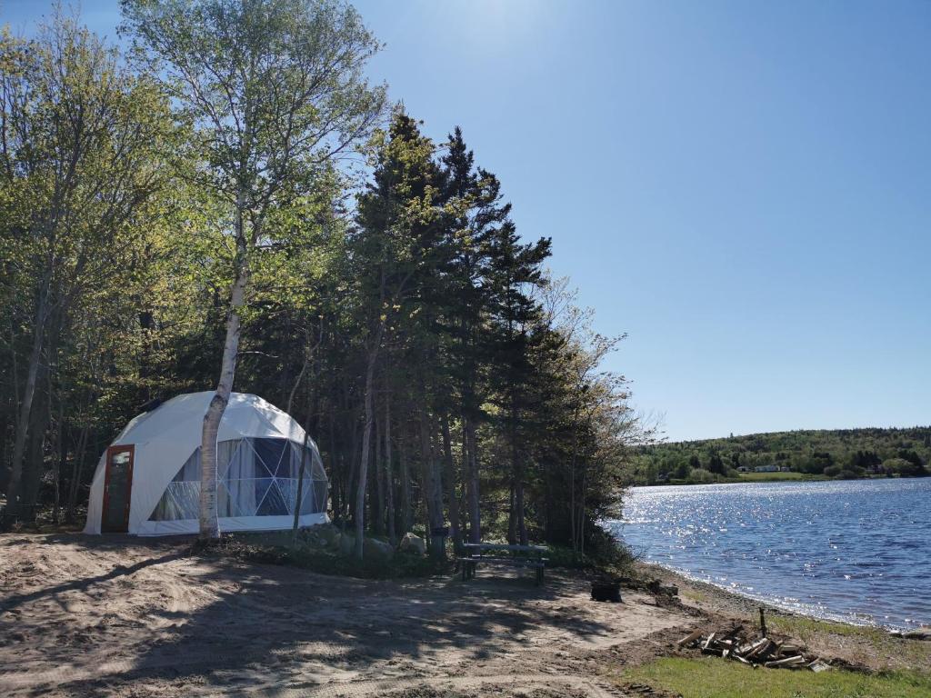 a tent on the shore of a lake at Blue Bayou Resort, Cape Breton in Dingwall
