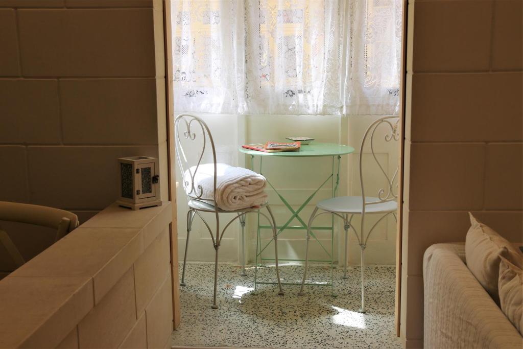 a room with a table and two chairs and a bed at Charming Home in Republic street in Valletta