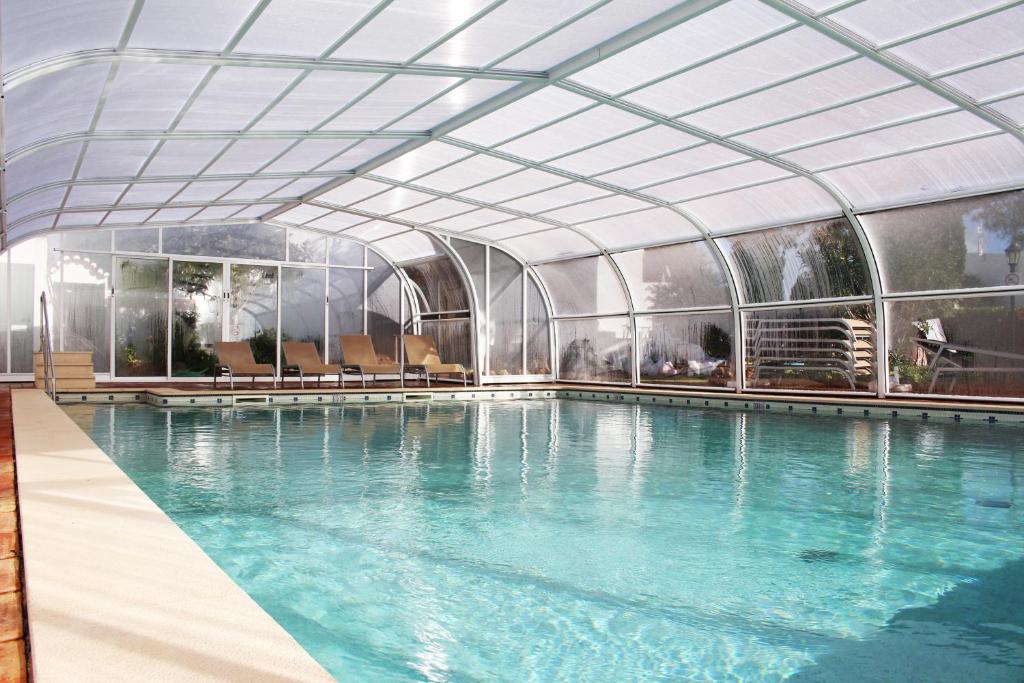 a large swimming pool with a glass ceiling at Rocha Brava Village Resort in Carvoeiro