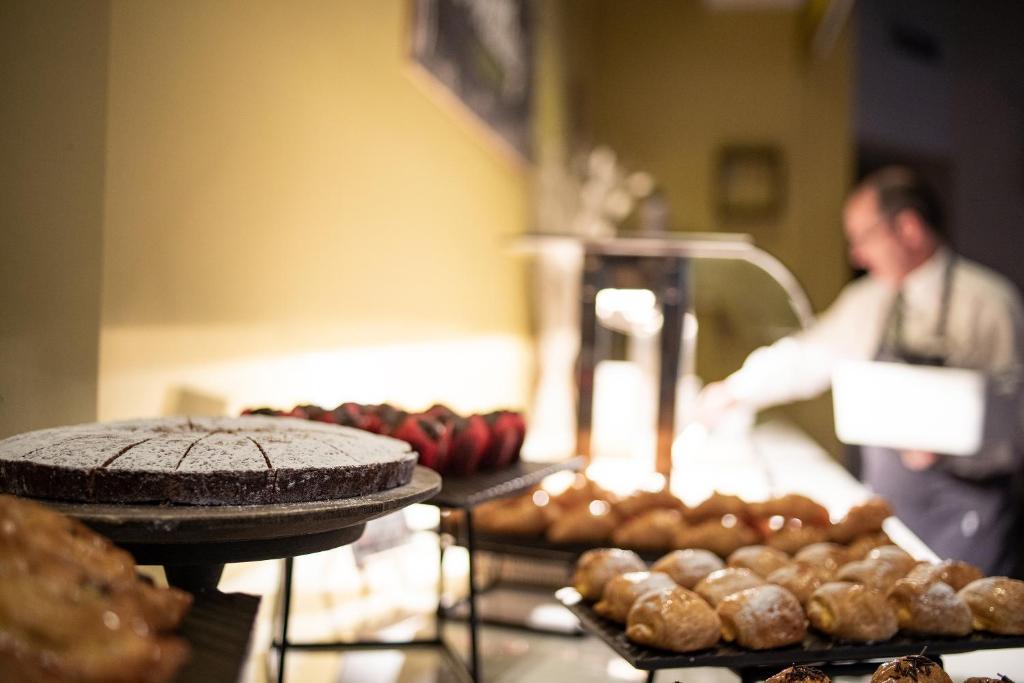 a man standing behind a counter with bread and pastries at Ona Alanda Club Marbella in Marbella