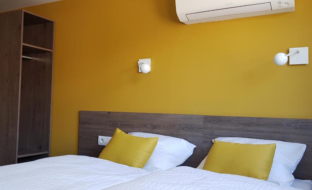 Postel nebo postele na pokoji v ubytování HOTEL L'AVENUE