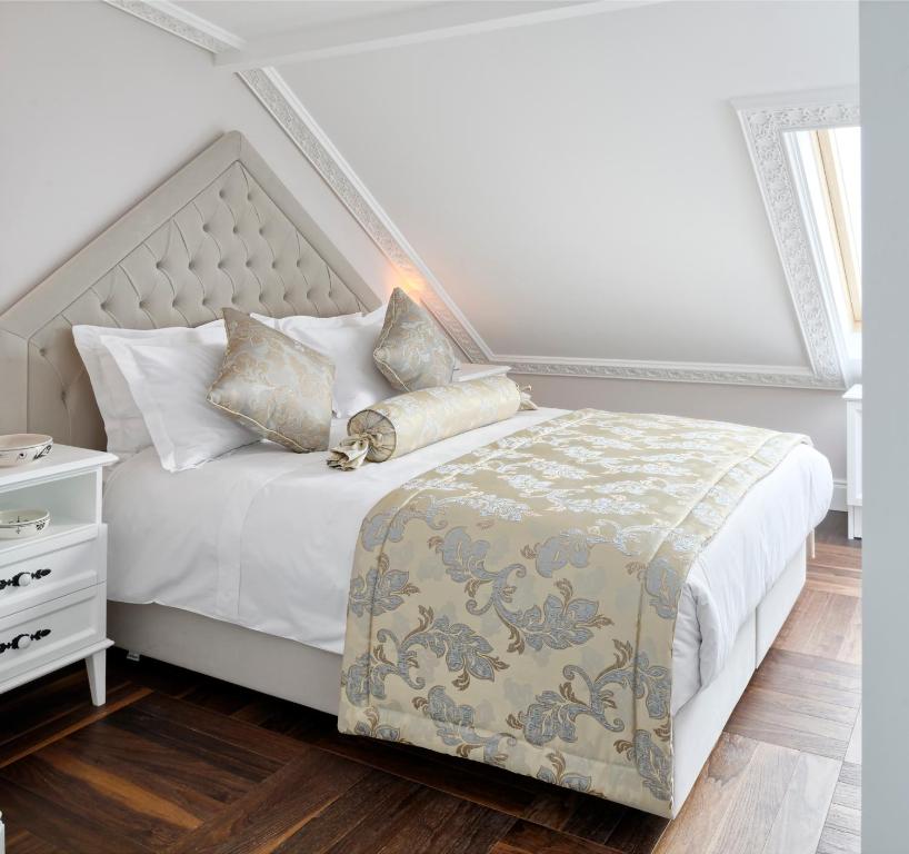 a bedroom with a white bedspread and white pillows at Nexthouse Pera Hotel in Istanbul